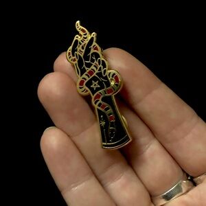 Golden hand with snake enamel metal pin